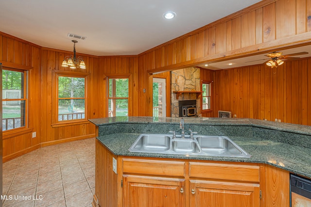 4005 Warriors Trl, Vicksburg, MS 39180 - kitchen featuring a sink, dishwasher, wooden walls, light tile patterned flooring, and a chandelier