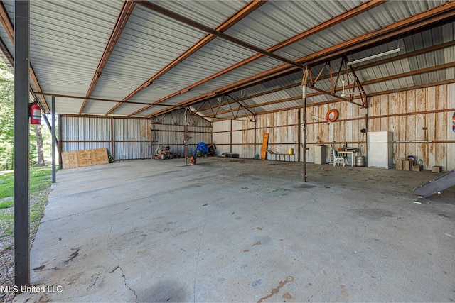 4005 Warriors Trl, Vicksburg, MS 39180 - garage featuring metal wall and freestanding refrigerator