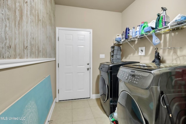 laundry room featuring light tile patterned floors and washing machine and clothes dryer