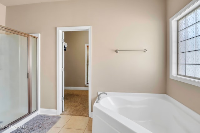 bathroom featuring shower with separate bathtub and tile patterned flooring