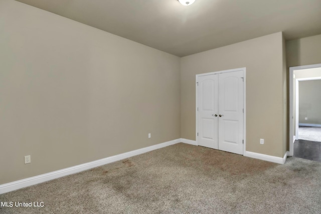 unfurnished bedroom with a closet and carpet flooring