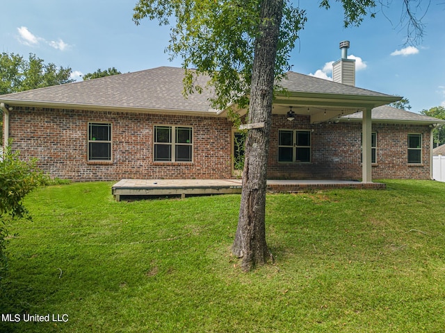 back of house with a patio area, a lawn, and ceiling fan