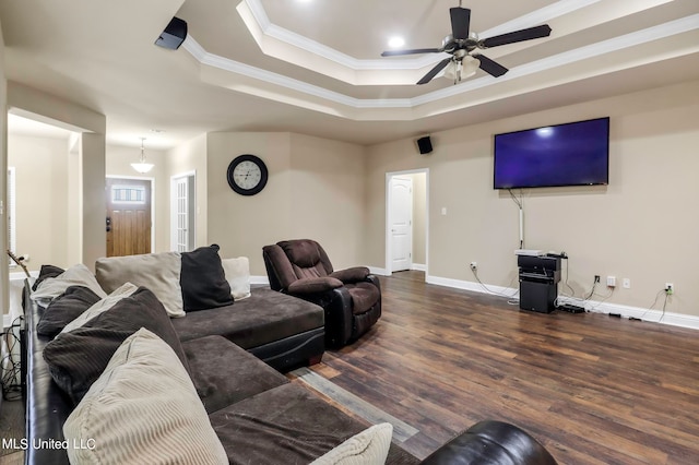 living room with crown molding, a raised ceiling, ceiling fan, and dark hardwood / wood-style flooring