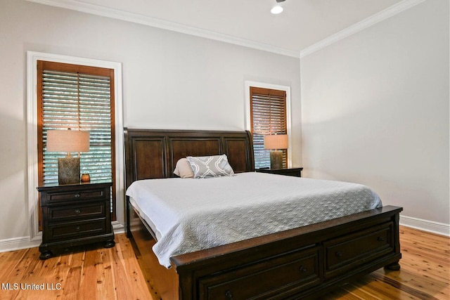 bedroom featuring crown molding and light hardwood / wood-style floors