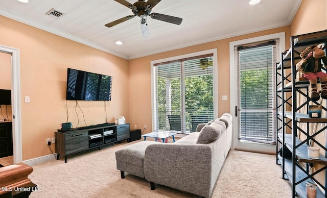 carpeted living room with ornamental molding and ceiling fan