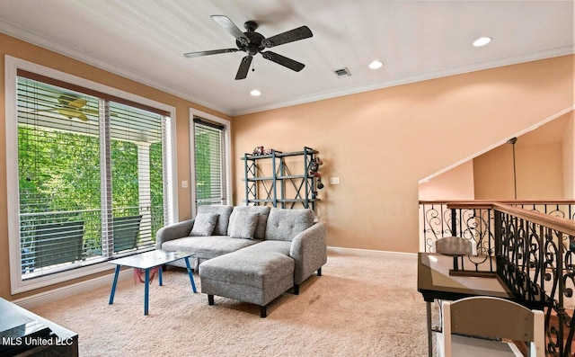 sitting room featuring ceiling fan, ornamental molding, and light carpet