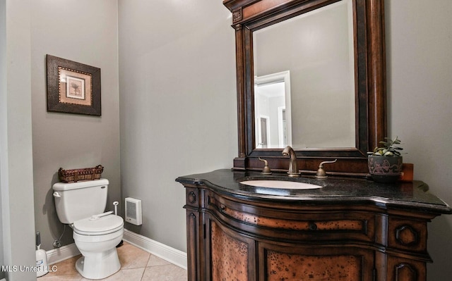 bathroom featuring vanity, tile patterned floors, and toilet