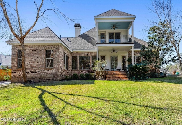 view of front of home featuring covered porch, a balcony, a front yard, and ceiling fan