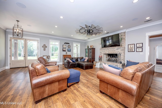 living room with recessed lighting, visible vents, light wood finished floors, and a fireplace