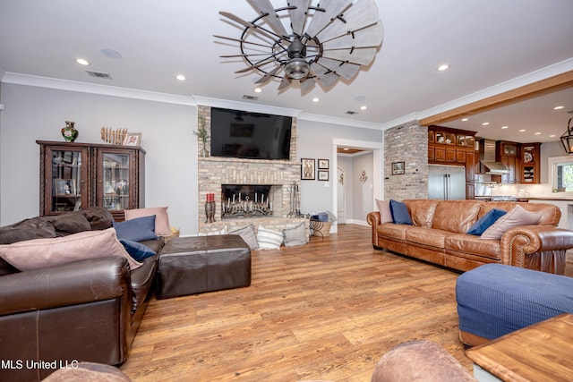 living room with light wood-style floors, ornamental molding, recessed lighting, and visible vents