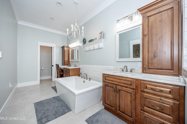 full bathroom featuring a sink, tile patterned floors, a chandelier, a freestanding tub, and two vanities