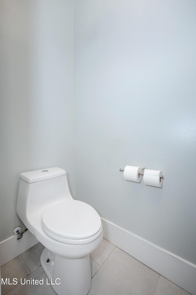 bathroom featuring tile patterned floors, baseboards, and toilet