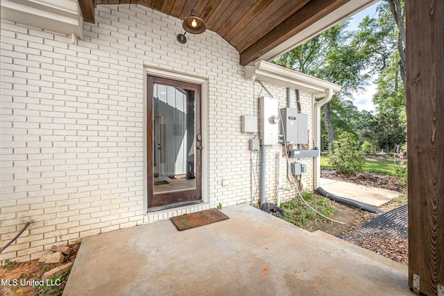 property entrance featuring brick siding