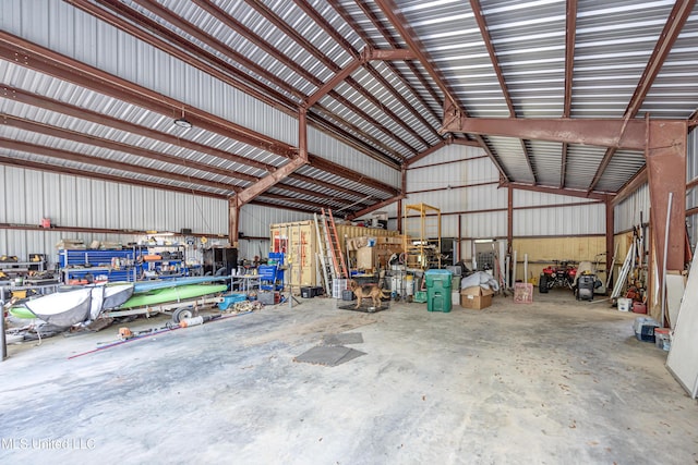 garage with a workshop area and metal wall