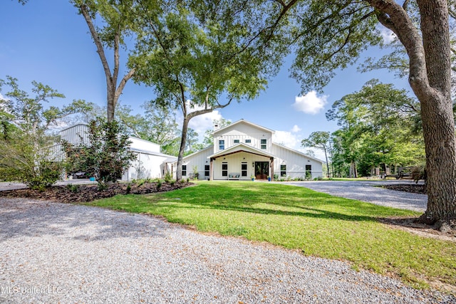 view of front of home featuring board and batten siding and a front yard