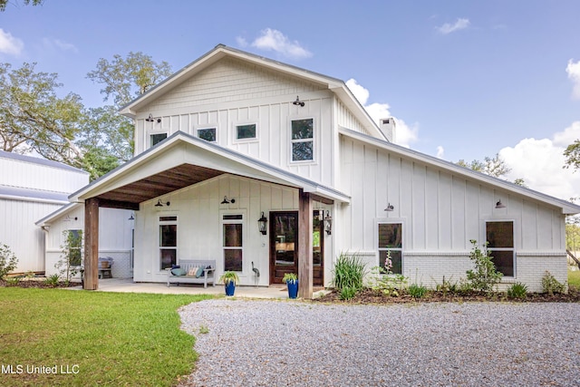 modern farmhouse style home with board and batten siding and a front yard