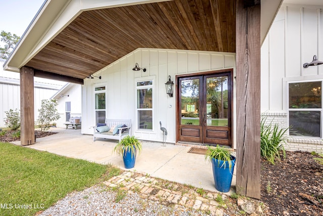 doorway to property featuring french doors and board and batten siding