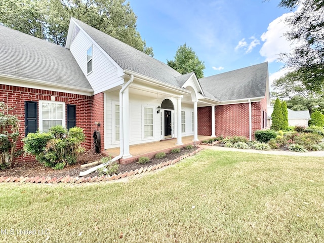 view of front facade with a patio and a front lawn