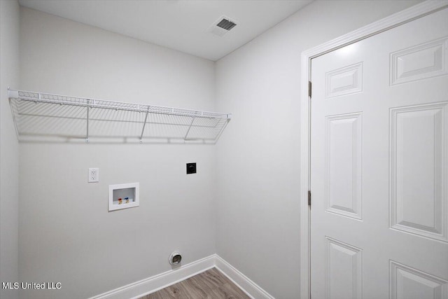 clothes washing area with electric dryer hookup, wood-type flooring, and washer hookup