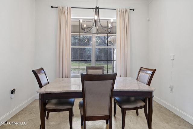 dining room with baseboards and a notable chandelier