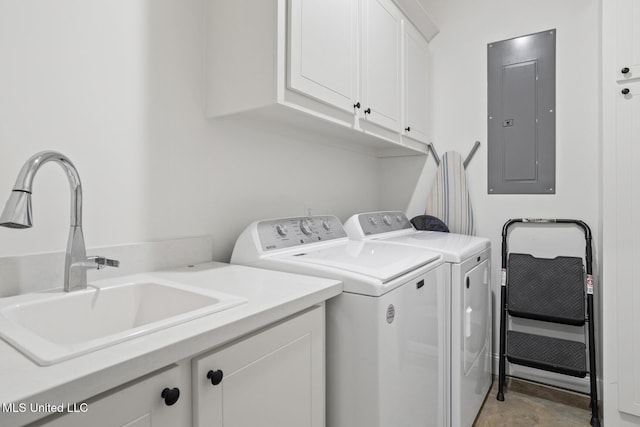 clothes washing area featuring cabinet space, electric panel, a sink, and washing machine and clothes dryer