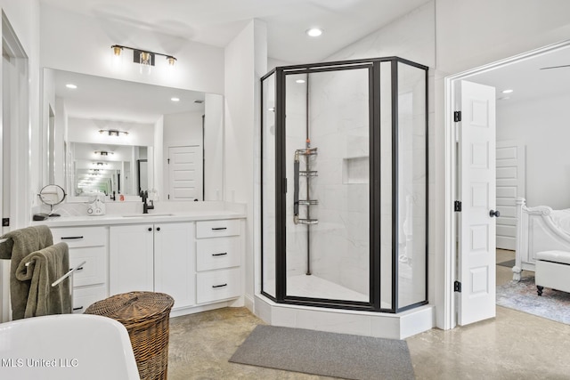 bathroom with ensuite bathroom, recessed lighting, vanity, a soaking tub, and a shower stall