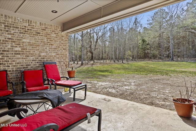 view of patio / terrace featuring a wooded view