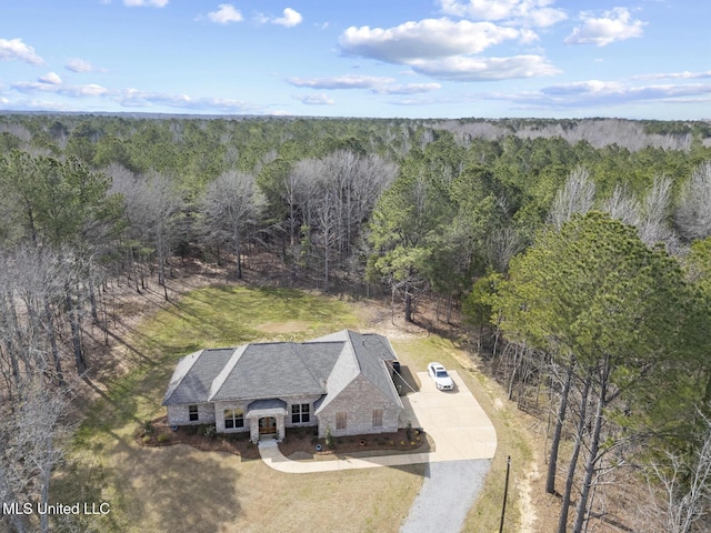 birds eye view of property with a view of trees