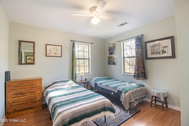 bedroom with hardwood / wood-style floors and ceiling fan