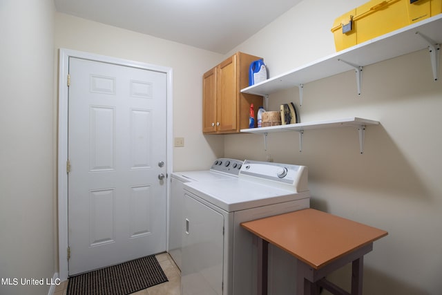 washroom with washer and clothes dryer and cabinets