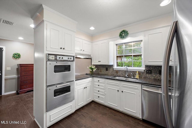 kitchen featuring sink, white cabinetry, stainless steel appliances, and dark hardwood / wood-style flooring