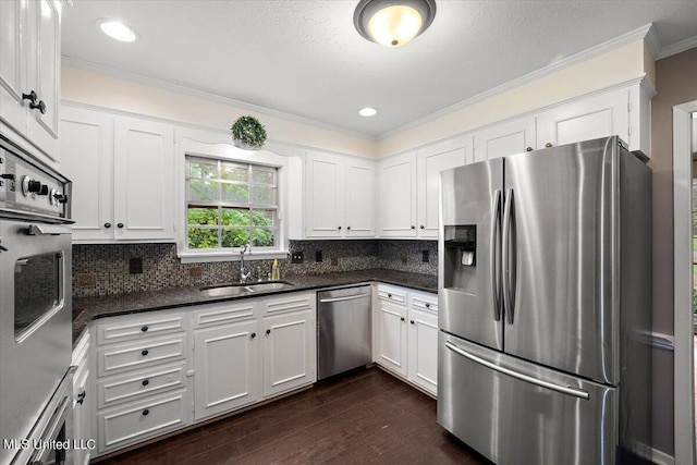 kitchen featuring sink, white cabinetry, stainless steel appliances, dark wood-type flooring, and ornamental molding