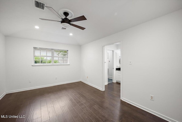 empty room featuring ceiling fan and dark hardwood / wood-style flooring