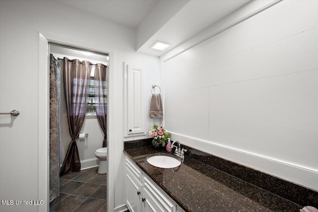 bathroom featuring vanity, toilet, and tile patterned flooring