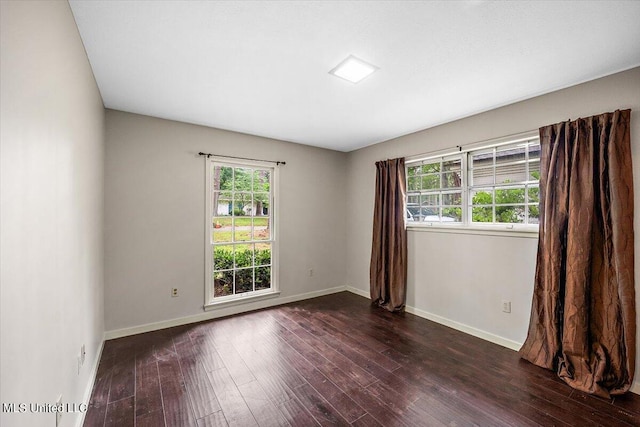 spare room featuring dark hardwood / wood-style floors