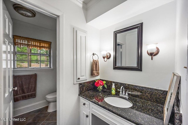 bathroom featuring toilet, ornamental molding, vanity, and tile patterned flooring