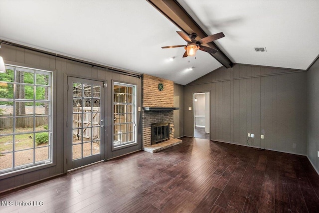 unfurnished living room featuring vaulted ceiling with beams, dark wood-type flooring, a fireplace, and ceiling fan