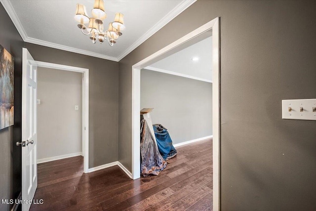 hall featuring ornamental molding, a notable chandelier, and dark hardwood / wood-style floors