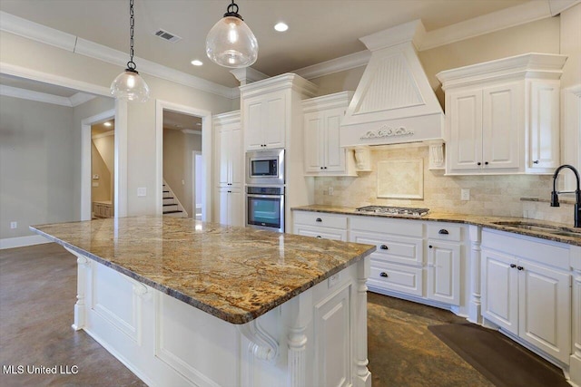 kitchen featuring premium range hood, appliances with stainless steel finishes, white cabinetry, sink, and a breakfast bar area