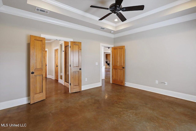 spare room with a tray ceiling, ornamental molding, and ceiling fan