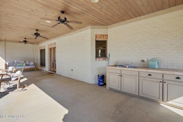 view of patio / terrace with ceiling fan, sink, and area for grilling