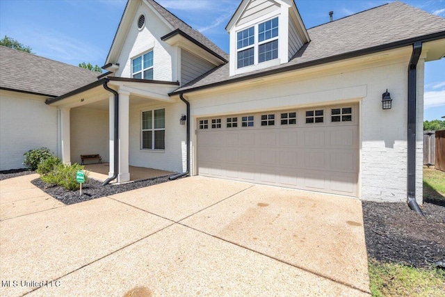 13604 Live Oak Loop, Olive Branch, MS 38654 - view of front facade with driveway, brick siding, a porch, and a garage