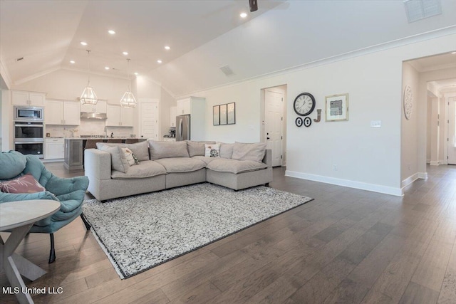 13604 Live Oak Loop, Olive Branch, MS 38654 - living area with vaulted ceiling, dark wood finished floors, baseboards, recessed lighting, and crown molding