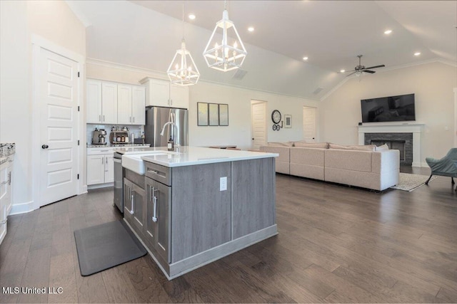 13604 Live Oak Loop, Olive Branch, MS 38654 - kitchen with a sink, lofted ceiling, a ceiling fan, white cabinetry, and stainless steel appliances