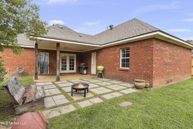 115 Deer Creek Cv, Madison, MS 39110 - back of property featuring an outdoor fire pit, a patio, a shingled roof, and brick siding