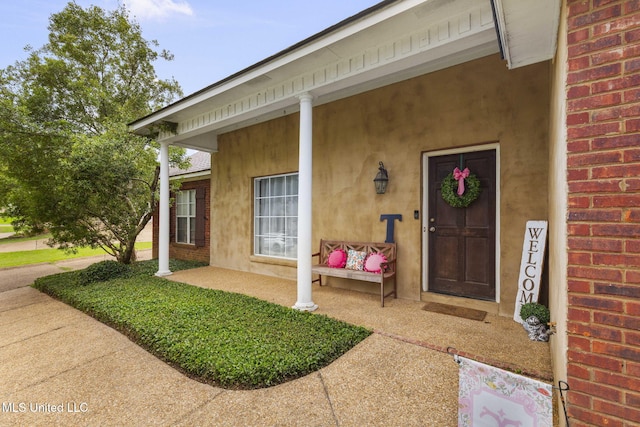 115 Deer Creek Cv, Madison, MS 39110 - property entrance with brick siding, covered porch, and stucco siding