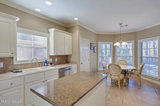 kitchen featuring dishwasher, a center island, sink, tasteful backsplash, and white cabinetry