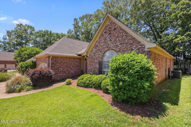 412 Dunlin Ct, Brandon, MS 39047 - view of front facade featuring brick siding, a front lawn, central AC unit, and a shingled roof
