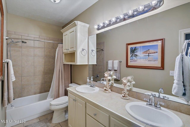 full bathroom featuring vanity, tile patterned floors, toilet, a textured ceiling, and shower / tub combo with curtain