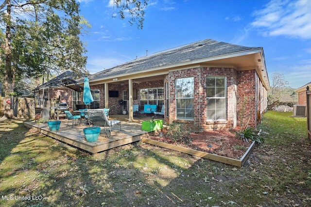 rear view of property featuring a wooden deck and cooling unit